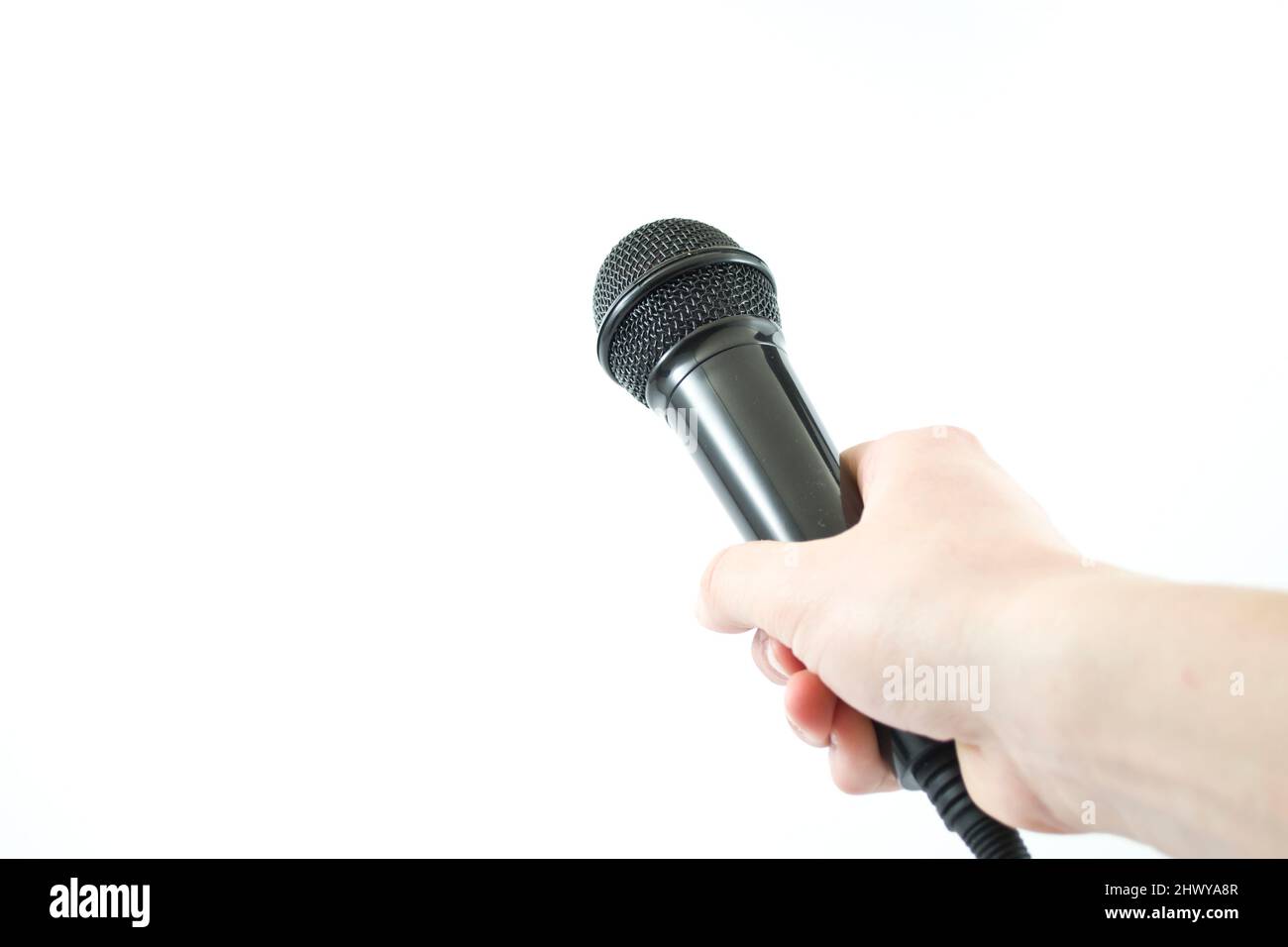 hand holding a microphone on white background Stock Photo