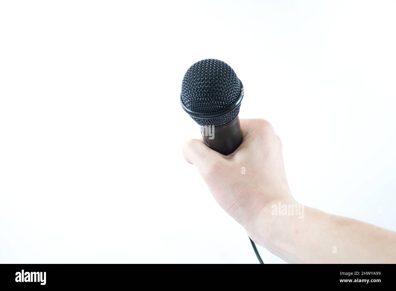 hand holding a microphone on white background Stock Photo Alamy