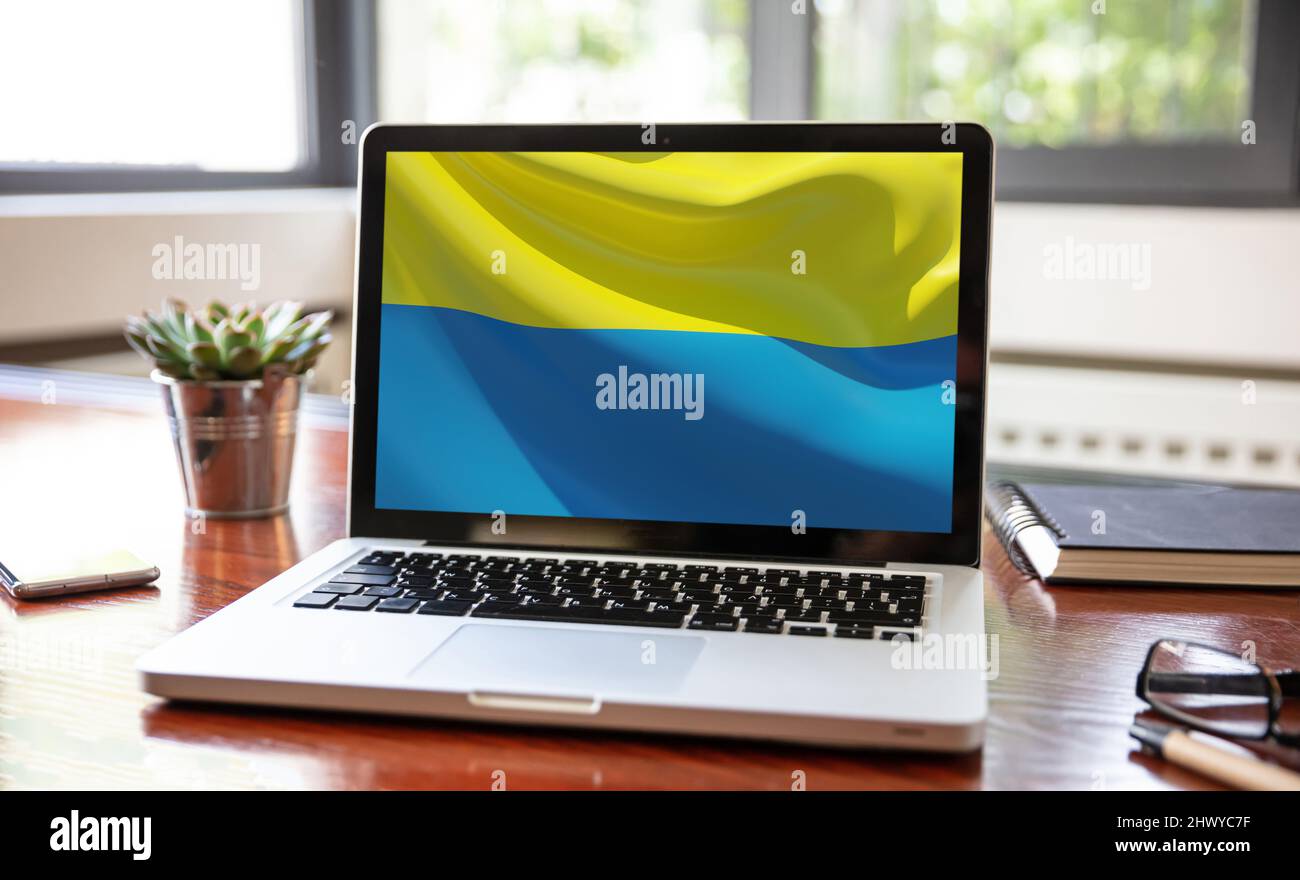 Support Ukraine, donate help Ukrainian people. flag on computer laptop screen. Business office