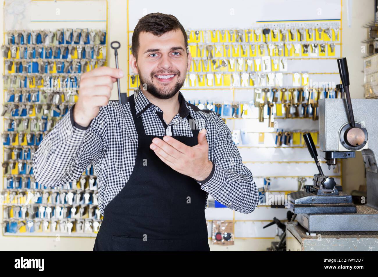 Male worker showing key he made in repair Stock Photo Alamy