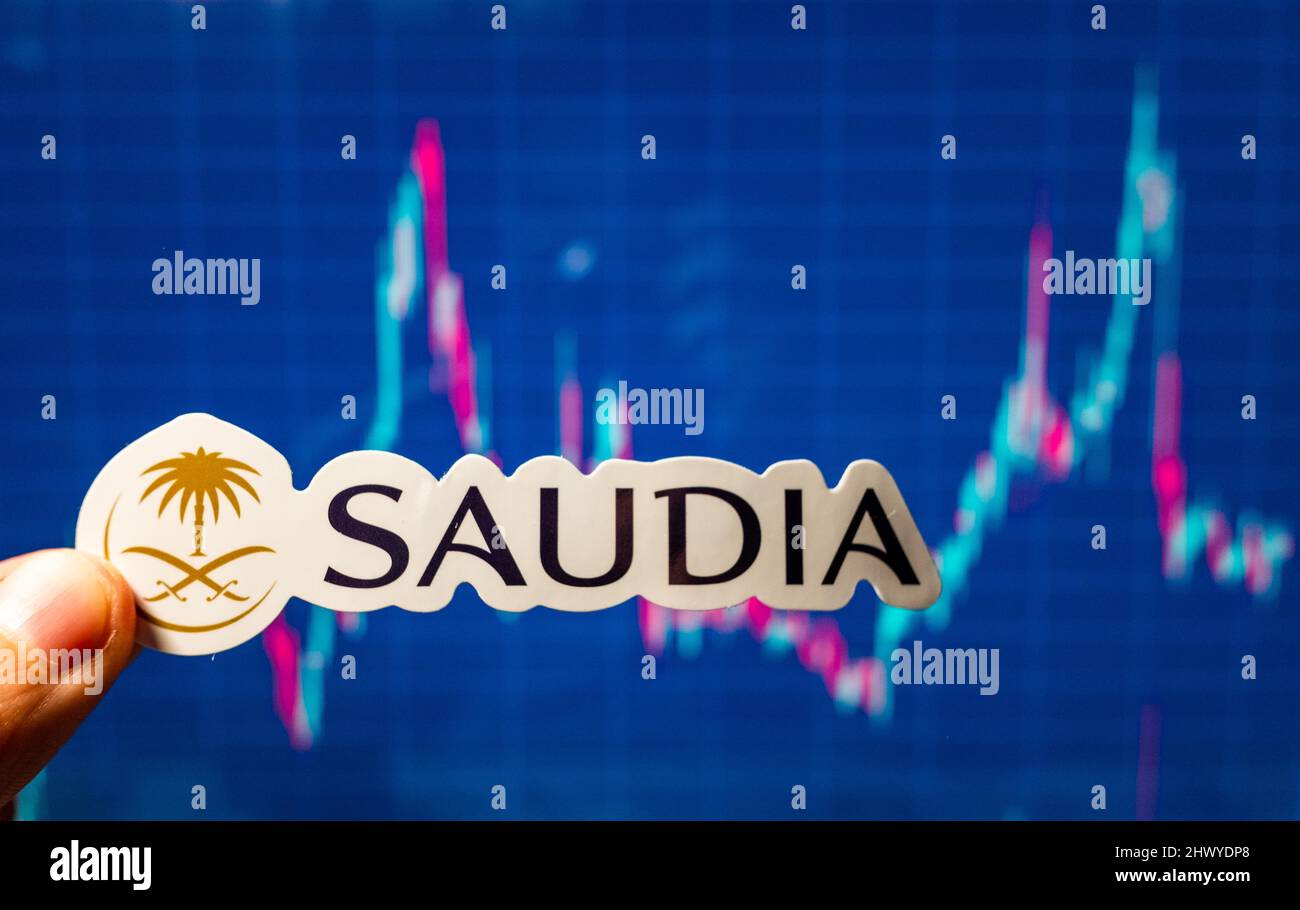 November 10, 2021, Jeddah, Saudi Arabia. The emblem of the Saudia airline against the background of a stock price chart. Stock Photo