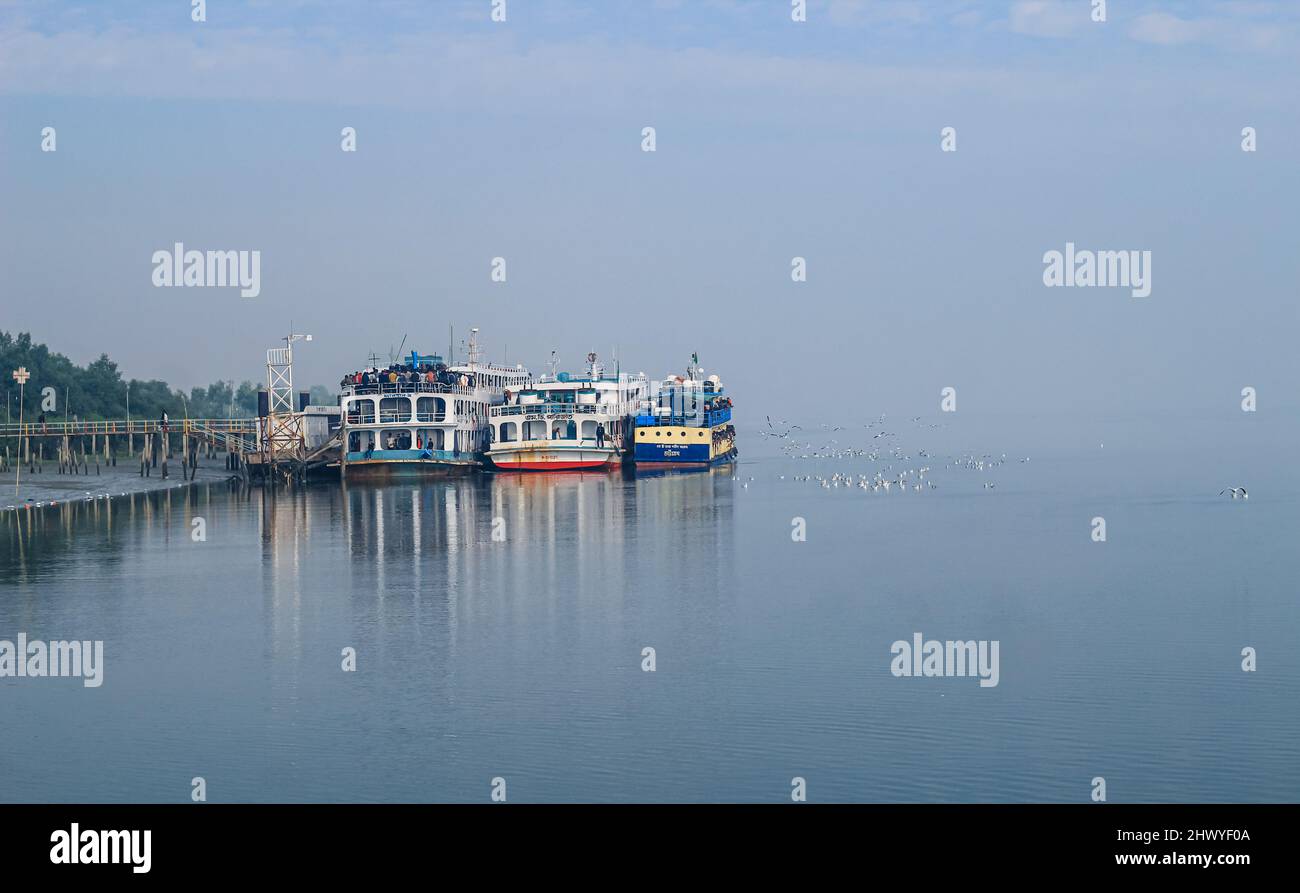 Tourist jetty of St. Martin's Island, Bangladesh. Photo of a seaport on an island with many ships docked. Good to use for outdoor. Stock Photo