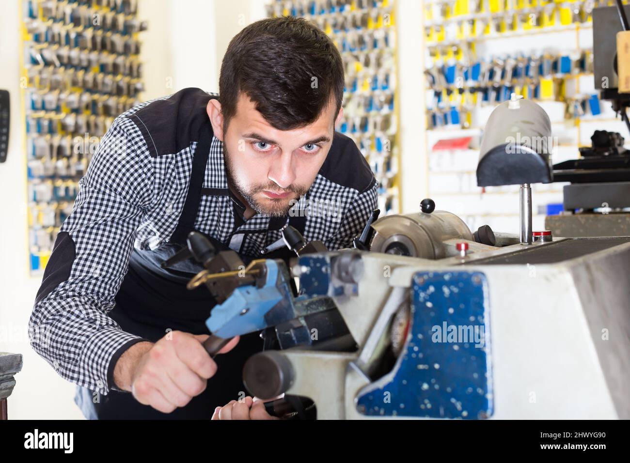 Adult male worker making key Stock Photo - Alamy