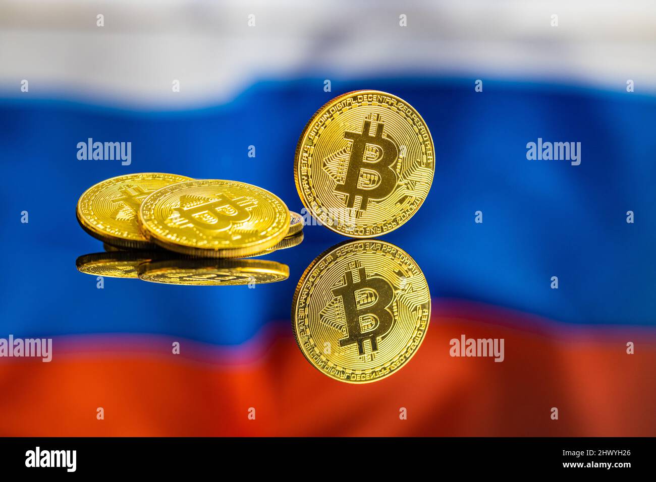 Bitcoin in front of russian flag. Digital cryptocurrency. The russian flag background. Stock Photo
