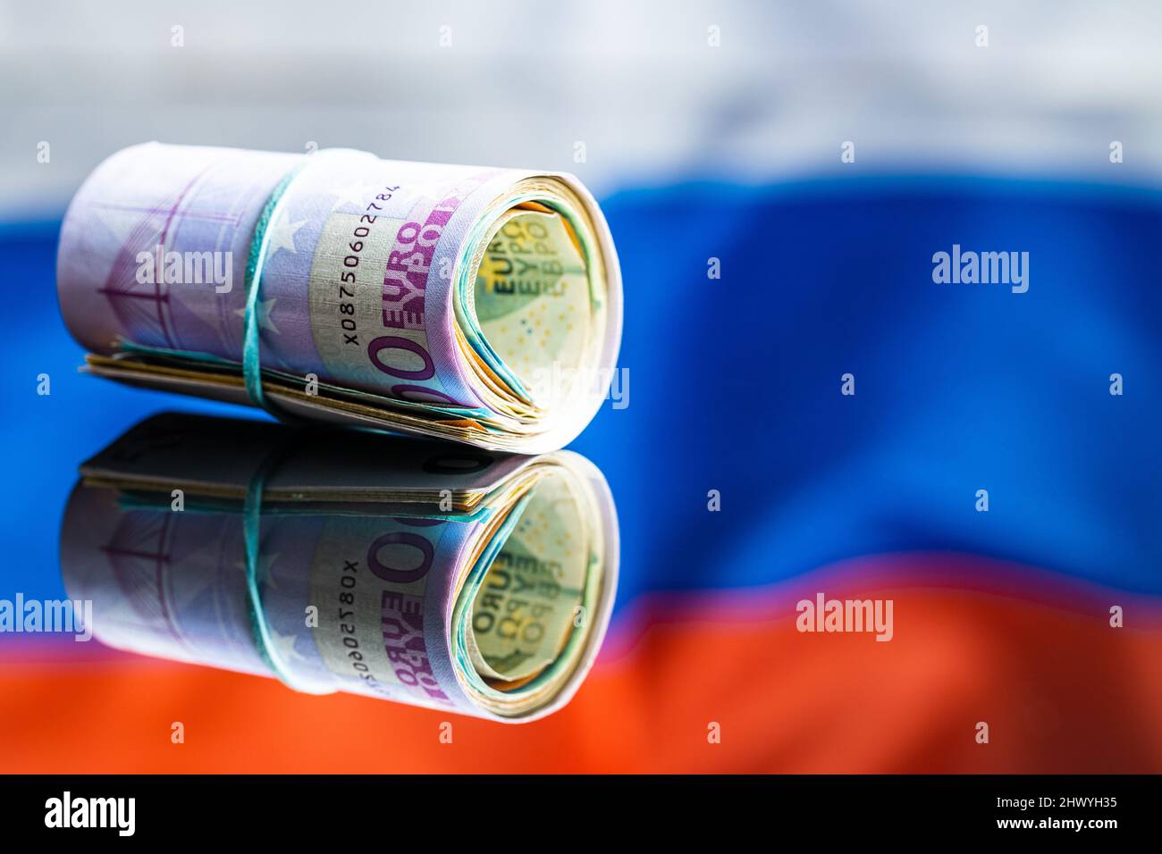 Euro banknotes in front of Russian flag. The paper European currency. Stock Photo