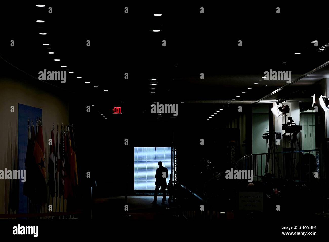 A person stands near a window in the United Nations (UN) headquarters building in the Manhattan borough of New York City, New York, U.S., March 8, 2022.  REUTERS/Carlo Allegri Stock Photo