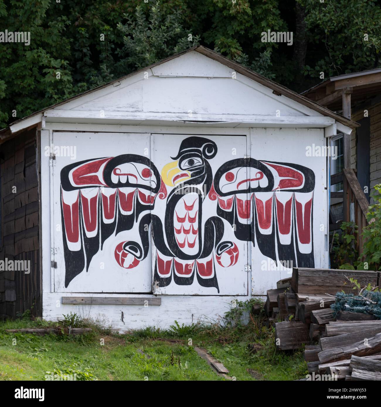 Indigenous Artwork on the exterior wall of a building in Alert Bay on Cormorant Island, Johnstone Strait, British Columbia, Vancouver Island, Canada Stock Photo
