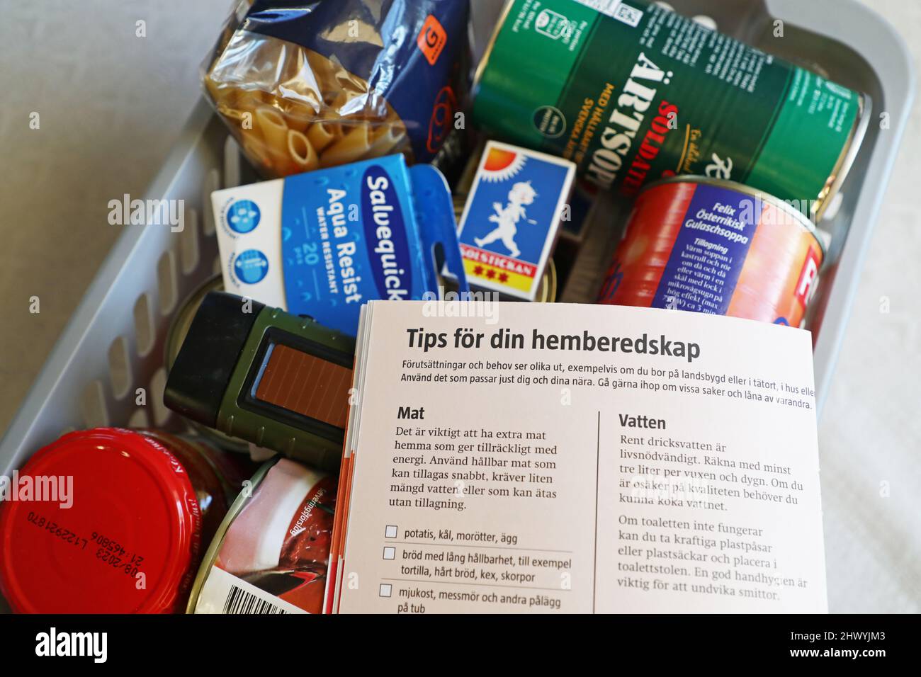 'If the war comes' information and and a box of food and other necessities in a home that might be needed in a crisis or war. Information on tips for your home equipment. 'If the war comes' (Swedish: Om kriget kommer) is a pamphlet originally prepared by the Supreme Commander of the Swedish Armed Forces' office. Stock Photo