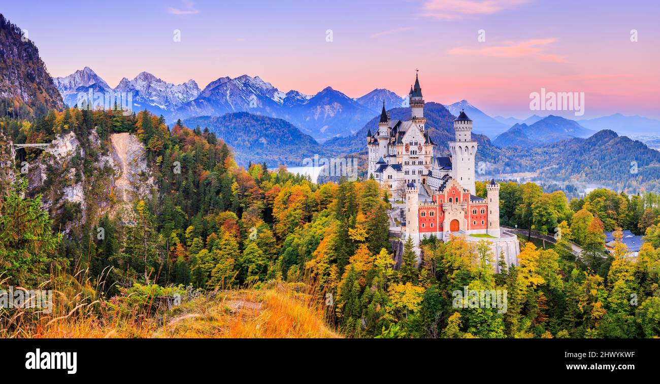 Neuschwanstein Castle (Schloss Neuschwanstein) Bavaria, Germany. Front view of the castle and Queen Mary's bridge at sunrise. The Bavarian Alps in the Stock Photo