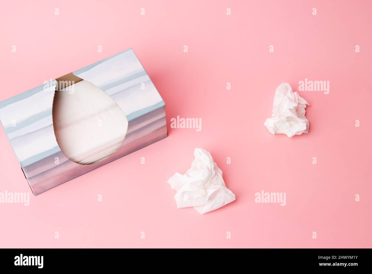 Tissue box with tissues on pink background Stock Photo