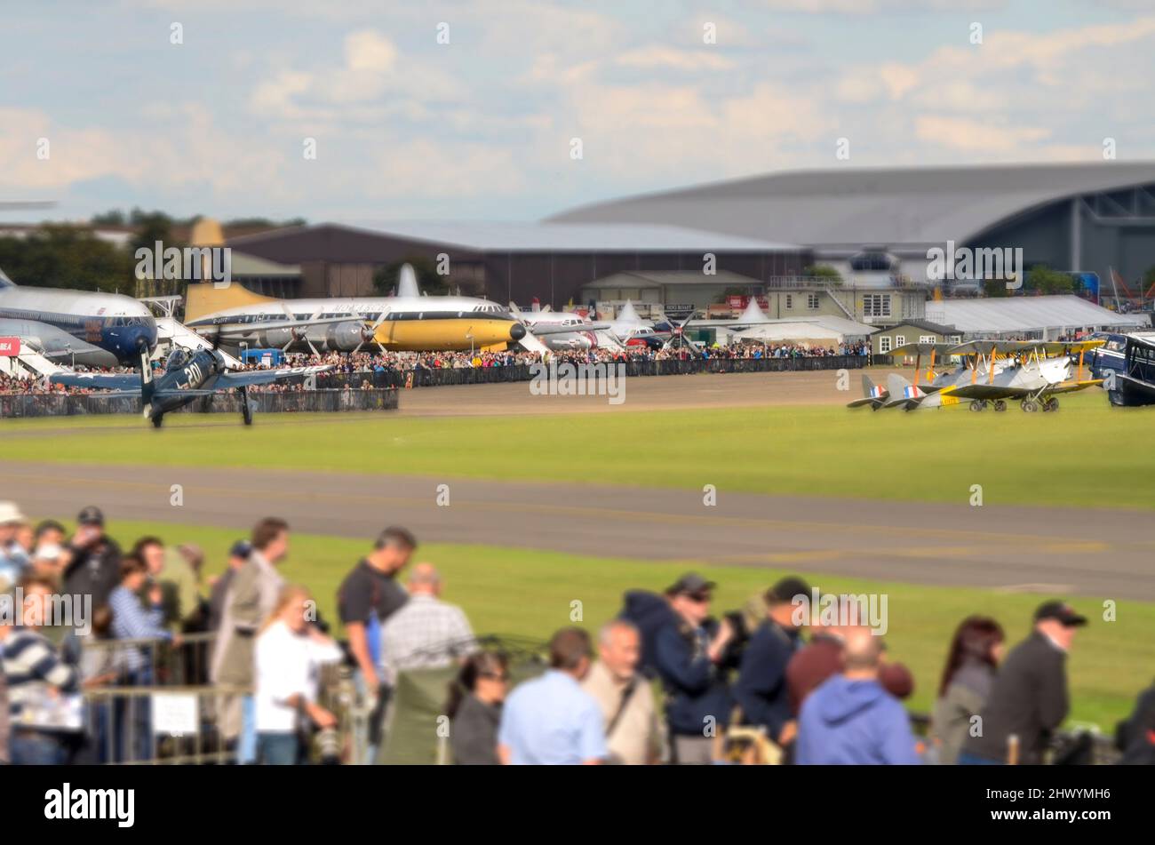 Second World War fighter plane taxiing past the crowd at the IWM Duxford during an airshow. Manipulated by in-camera tilt shift mode on Nikon D7000 Stock Photo