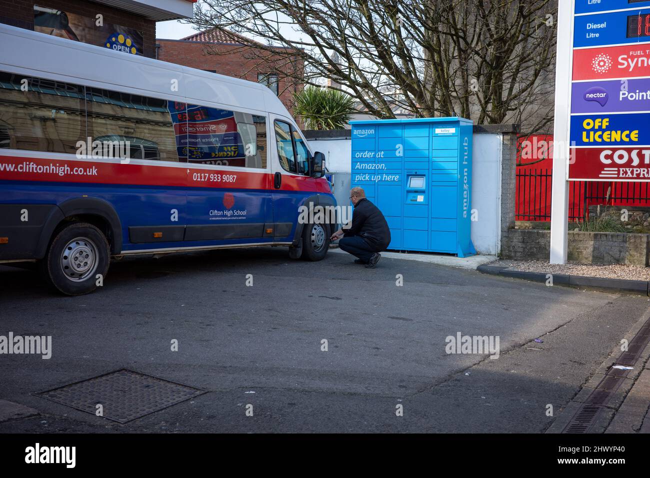 Man checking the tyre pressure on his mini bus (Mar 22) Stock Photo