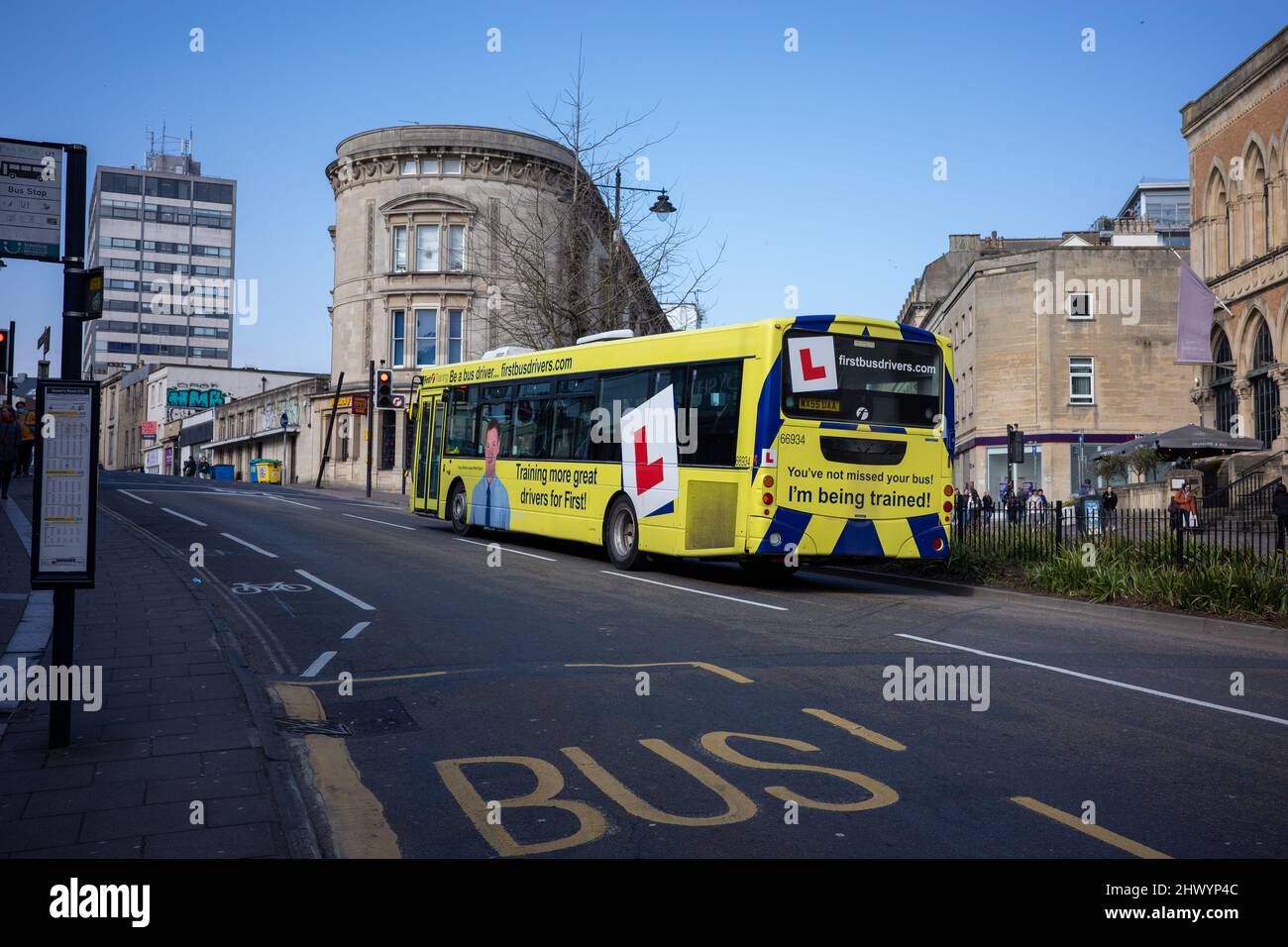 Yellow learner bus in Bristol (Mar22) Stock Photo