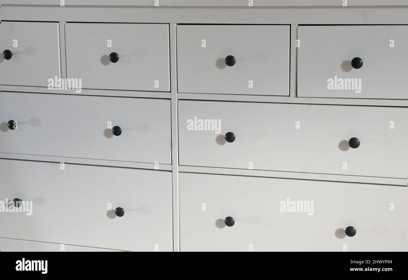 detail of large white chest of drawers Stock Photo