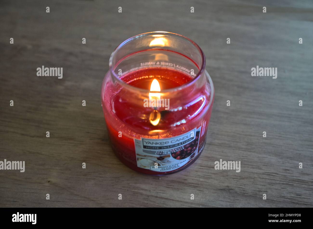 lit yankee candle on table top Stock Photo