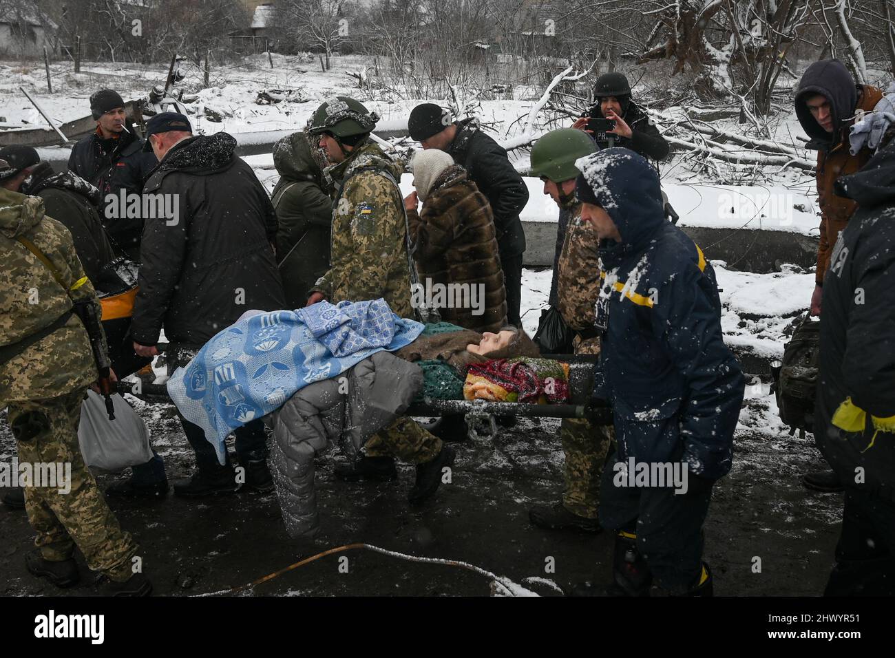 Evacuation efforts of Irpin continue through adverse weather conditions.  Ukrainian first responders and volunteers ferried refugees to Kyiv in buses  and vans. Irpin, Ukraine, March 8, 2022. Civilians have been evacuating the