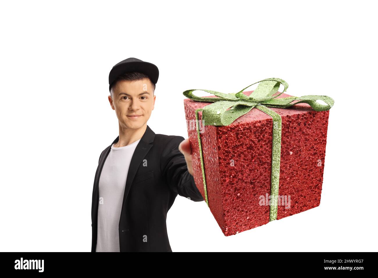 Handsome fashionable guy holding a red gift box isolated on white background Stock Photo