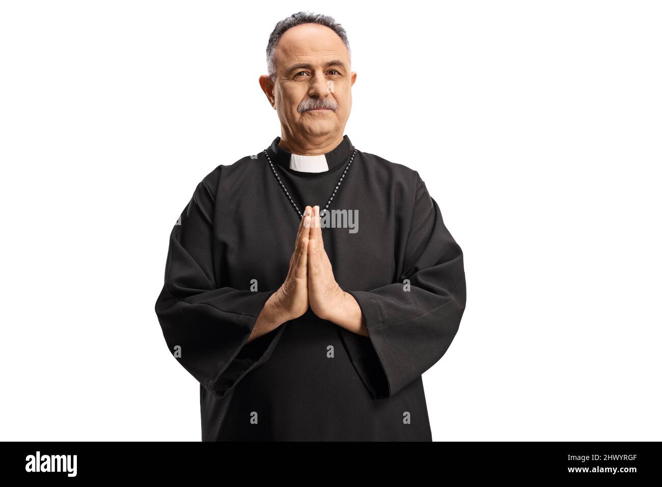 Mature priest with praying hands isolated on white background Stock Photo
