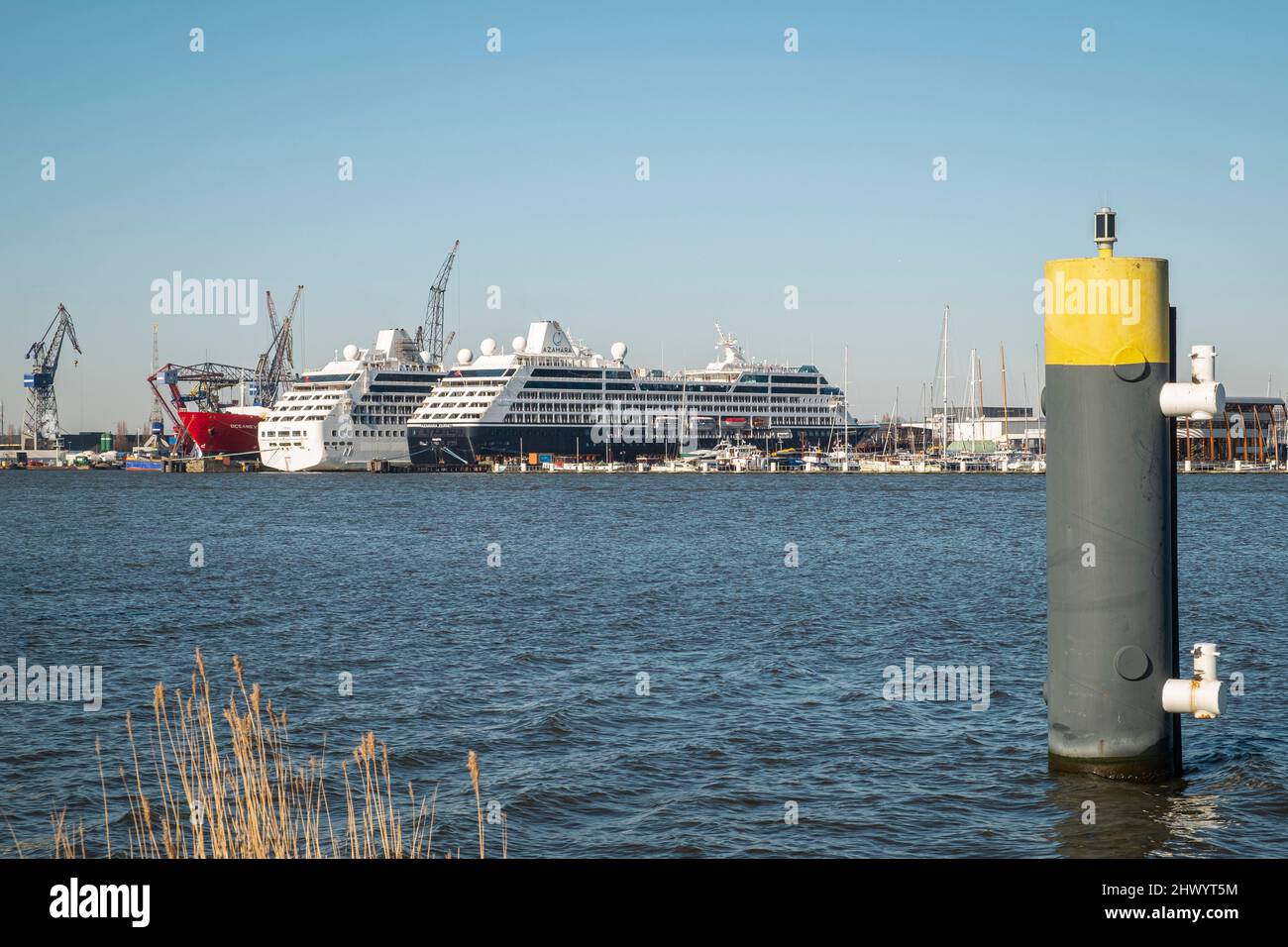 Cruise ships lie at moorings in the Amsterdam harbour. Stock Photo