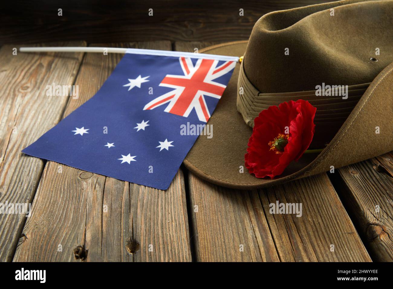 Anzac army slouch hat with Australian Flag and Poppy on wooden background Stock Photo