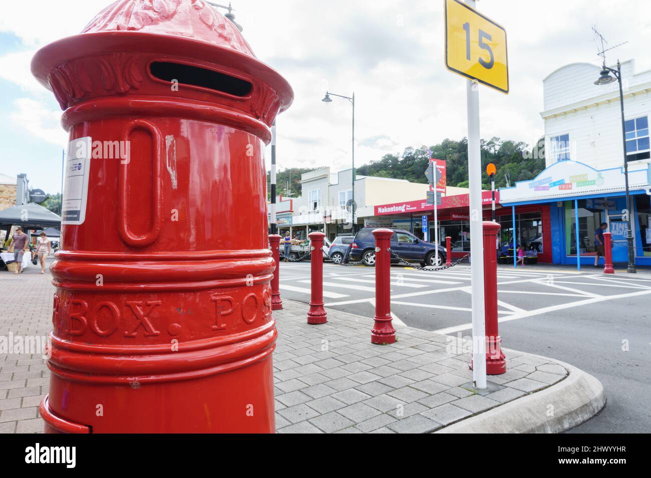 Thames New Zealand - April 11 2015;Low point of view of urban street with bright red traditional post box on corner Stock Photo