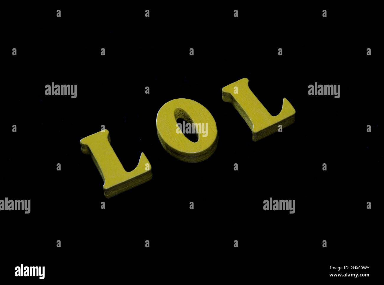 Lol - laughing out loud, funny acronym used in text messages. 3d letters on black Stock Photo
