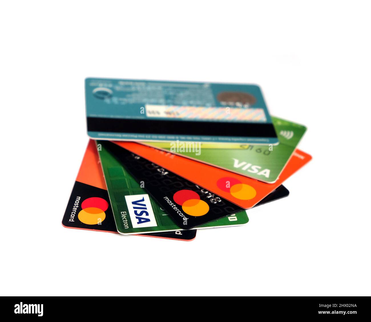 Several Visa and Mastercard bank cards are fanned out isolated on white ...