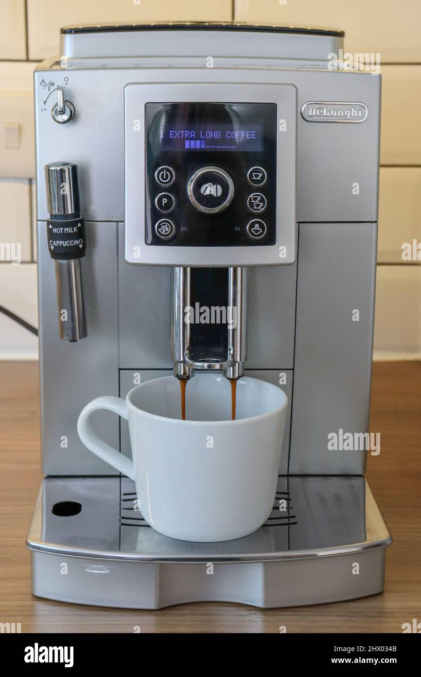DeLonghi bean to cup coffee machine dispensing fresh coffee in to a white  cup Stock Photo - Alamy