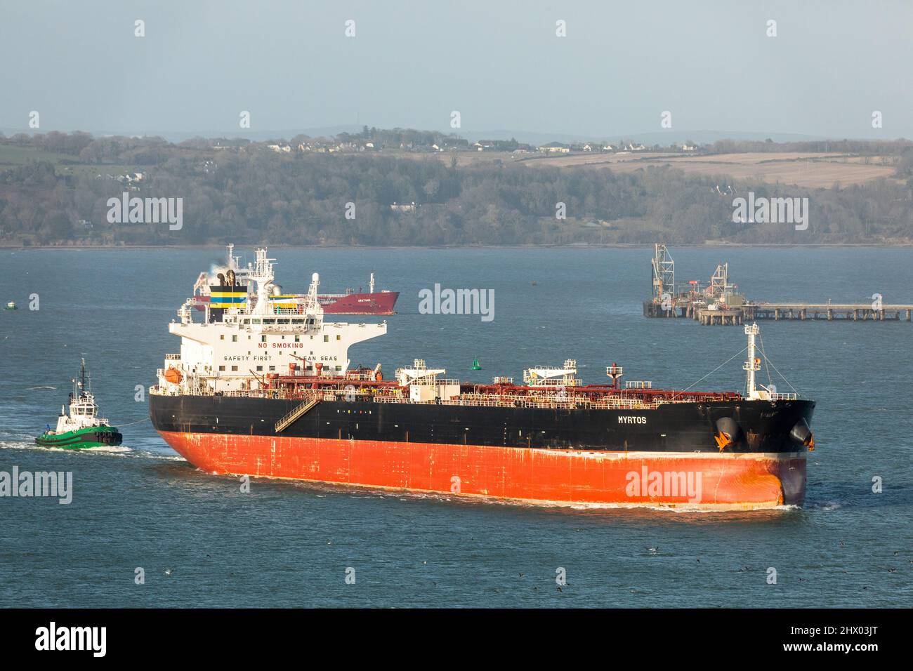 Whitegate, Cork, Ireland. 08th March, 2022. Tugboat DSG Alex escorts  the tanker Myrtos  oil refinery after discharging her cargo of U.S. crude oil at Whitegate, Co. Cork, Ireland - Picture David Creedon Stock Photo