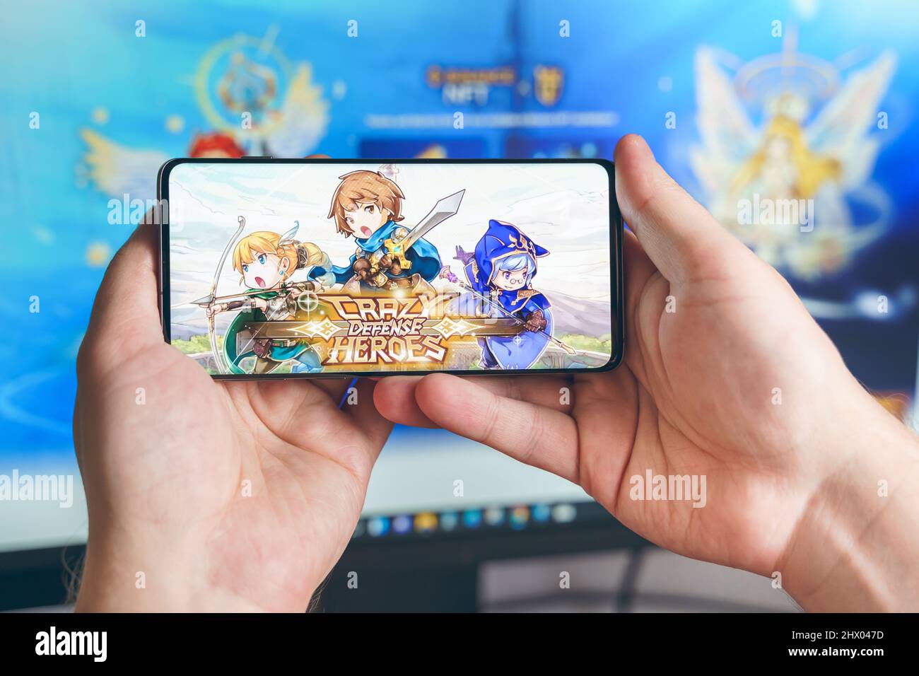 Russia Moscow 25.12.2021 Logo of Crazy Defense Heroes. Blockchain nft ethereum  cryptocurrency strategy game in laptop,mobile phone.Man playing for cry  Stock Photo - Alamy