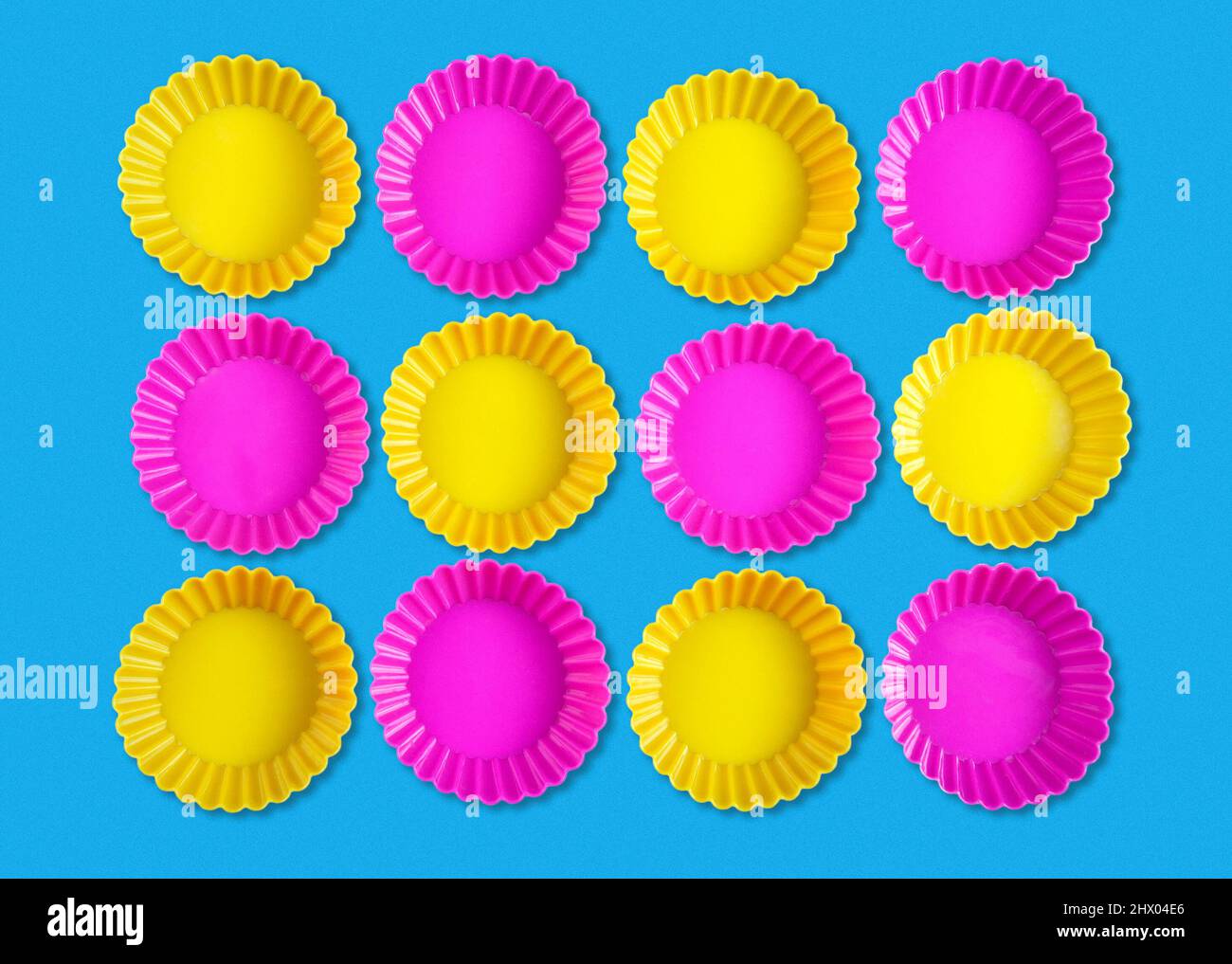 Abstract shapes background with group of yellow and pink rounded objects on blue background Stock Photo