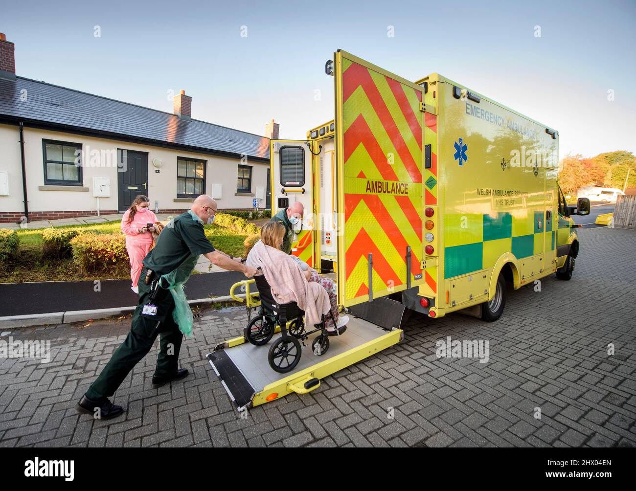 Paramedics move a patient to their ambulance after examining the patient in their home near Pontypool, S. Wales UK Stock Photo