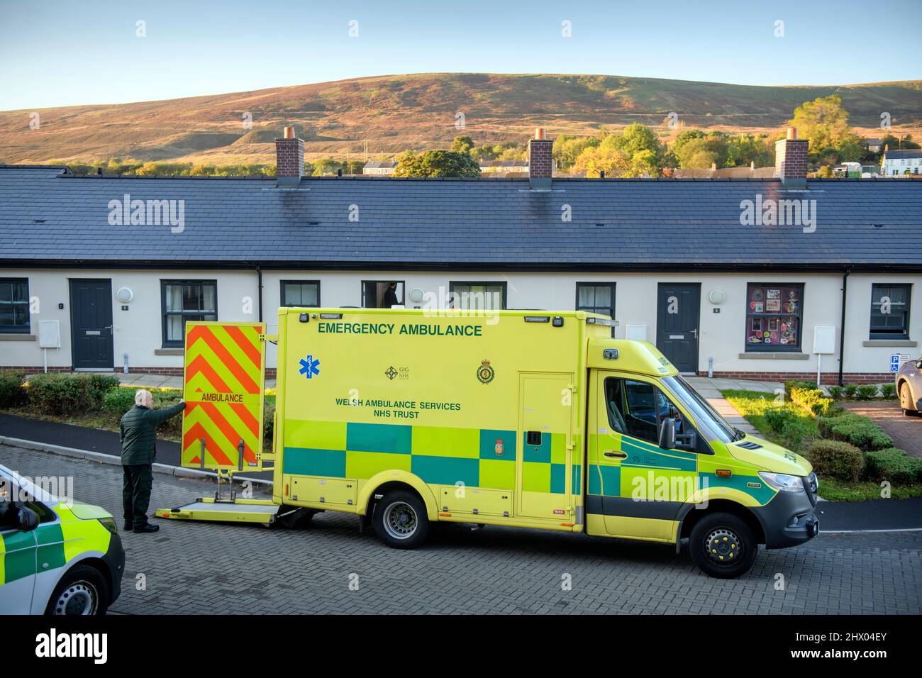 Paramedics move a patient to their ambulance after examining the patient in their home near Pontypool, S. Wales UK Stock Photo