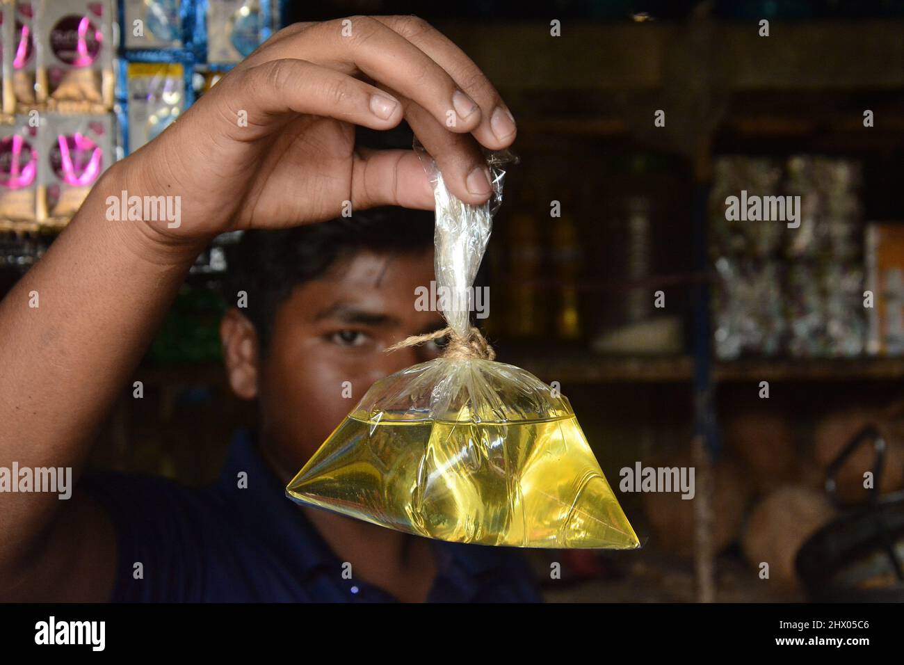 People with limited income are suffering due to abnormal rise in edible oil prices. Those who could not afford to buy a one liter, five liter bottle o Stock Photo