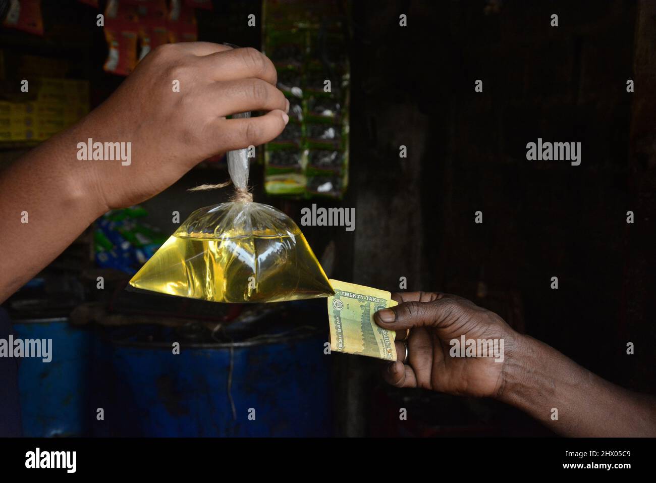 People with limited income are suffering due to abnormal rise in edible oil prices. Those who could not afford to buy a one liter, five liter bottle o Stock Photo