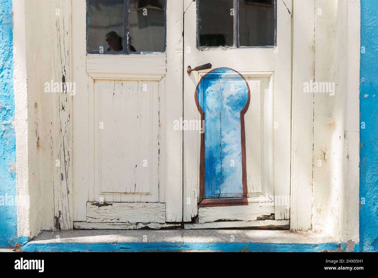An old door decorated with a keyhole painting Stock Photo