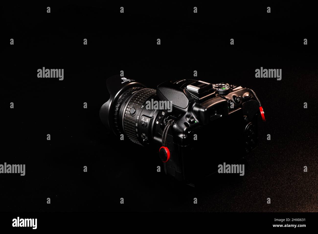 A camera from Nikon with lens in front of a black background on the