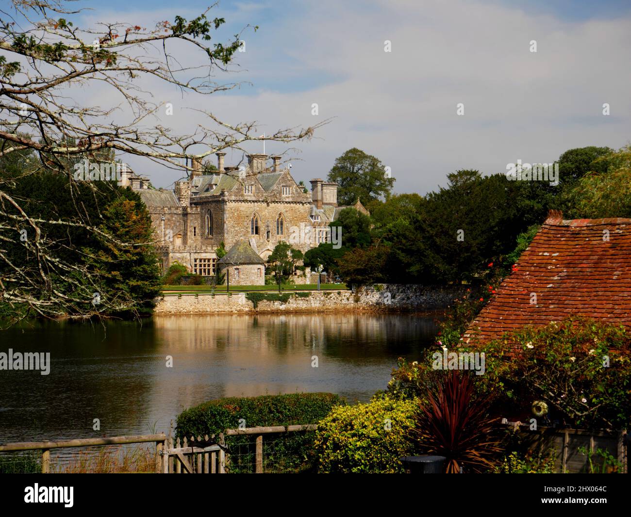 Palace House, Beaulieu, seen from across the Beaulieu River and Mill Dam, New Forest, Hampshire. Stock Photo