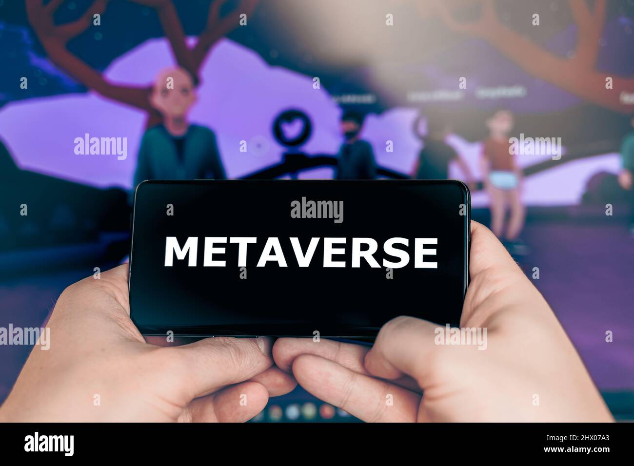 Russia Moscow 19.01.2022 Logo of Metaverse crypto game. Virtual world. Blockchain nft cryptocurrency strategy. Man playing in mobile phone for coin Stock Photo