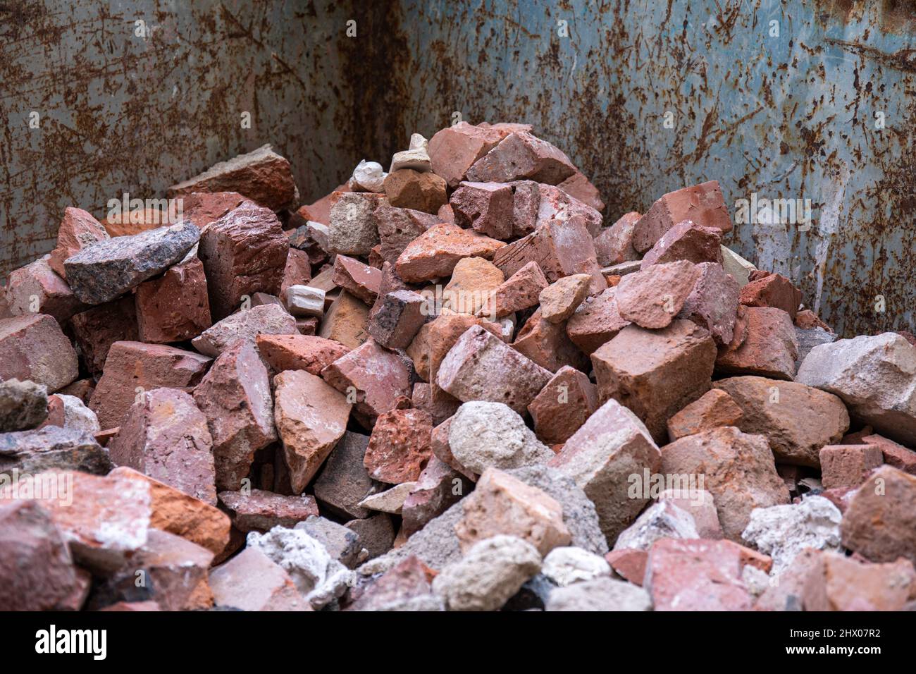 https://c8.alamy.com/comp/2HX07R2/broken-red-bricks-from-demolished-wall-in-construction-waste-container-2HX07R2.jpg
