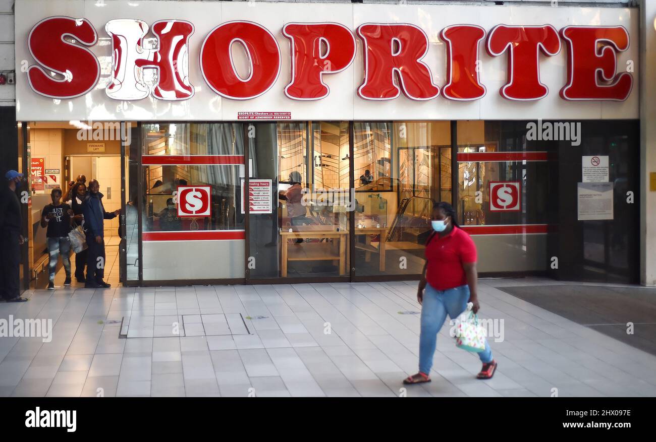 Cape Town, South Africa. 8th Mar, 2022. A person walks past a Shoprite