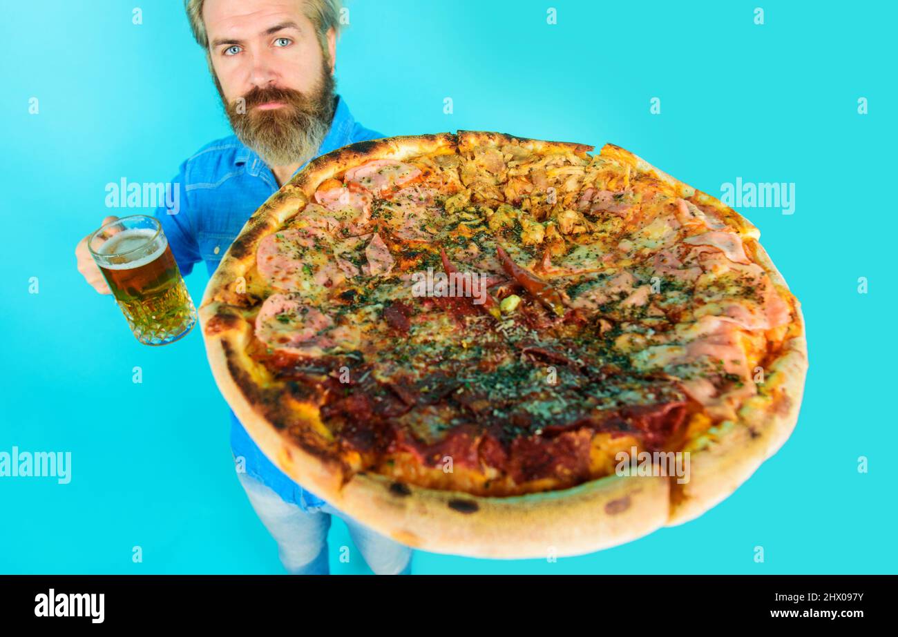 Man with pizza and mug of beer. Restaurant or pizzeria. Italian cuisine. Delicious fast food meal. Stock Photo