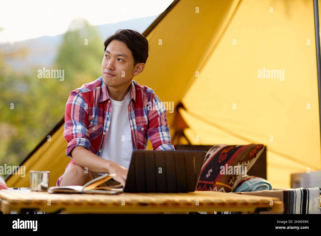 Japanese Man Teleworking At Campsite Stock Photo Alamy