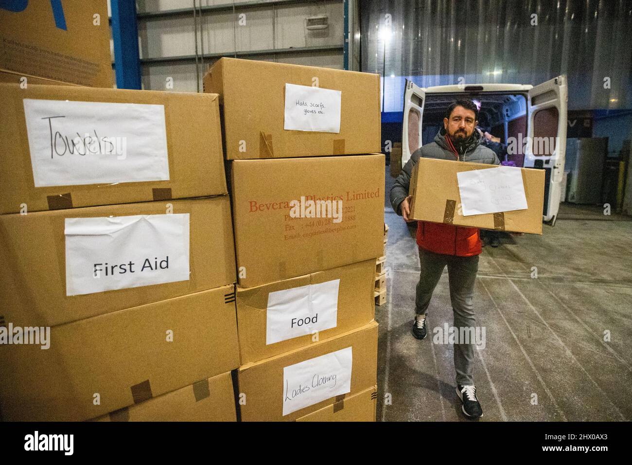 Paul Doherty (left), founder of Woodstock in west Belfast offloading donations given by people from Co. Armagh, at global transport and logistics company, DSV, in Belfast that will be packaged and shipped to go to the people of Ukraine. Picture date: Tuesday March 8, 2022. Stock Photo