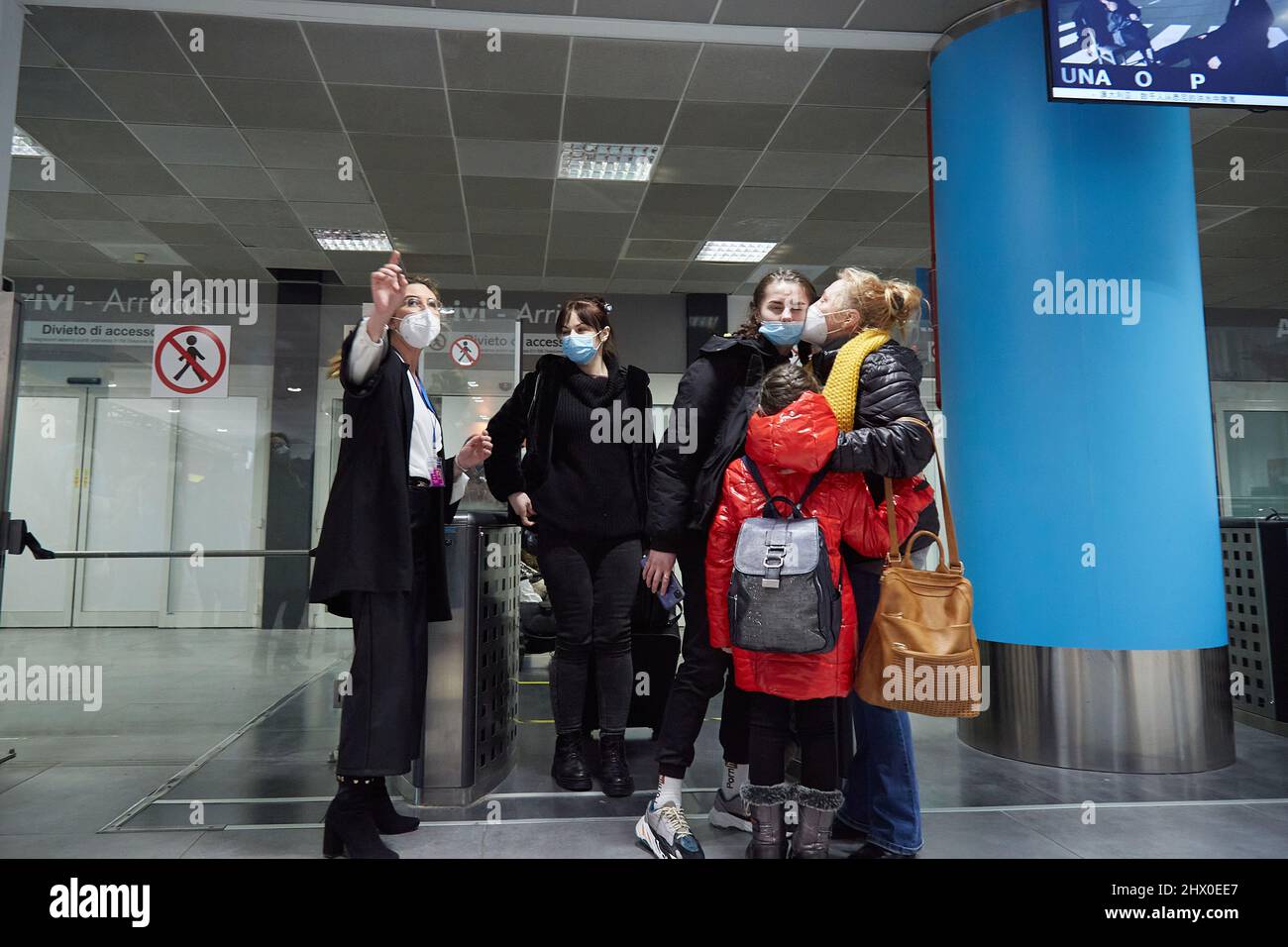 Palermo, Sicily, Italy. 8th Mar, 2022. Arrival of the first Ukrainian refugees in Palermo.The flight, from Krakow, Poland, landed around 5:00 p.m. at the Falcone Borsellino airport in Punta Raisi, Palermo.Upon arrival, refugees, welcomed by relatives and UNHCR volunteers, have carried out the anti-COVID protocol before leaving the airport. Citizen of Ukrainian origin greets her granddaughters. (Credit Image: © Victoria Herranz/ZUMA Press Wire) Stock Photo
