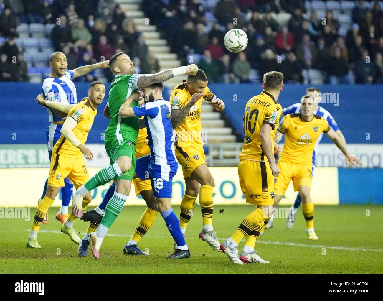 Sutton United goalkeeper Dean Bouzanis makes a save during the Papa