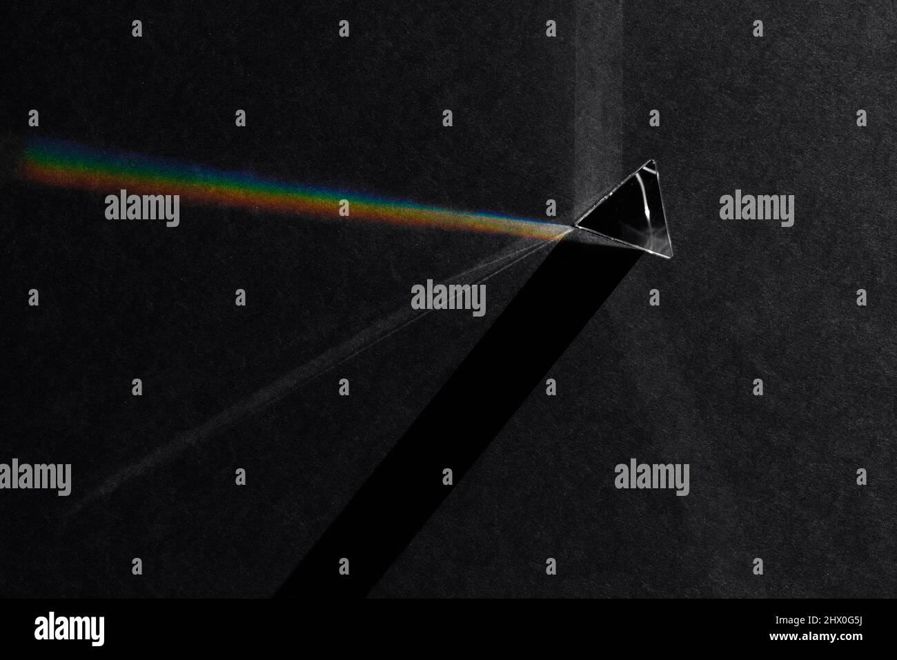 Top View of Prism Refracting Light to Create Shadows and Rainbow Stock Photo