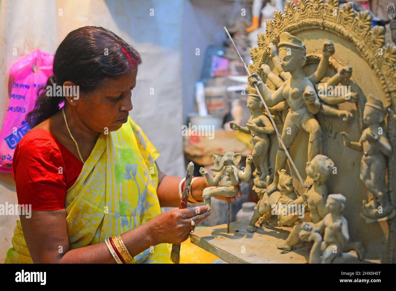 Kolkata, West Bengal, India. 8th Mar, 2022. Mala Pal who was a famous women sculptors in India. She started making gods sculptures after her father's death when she was 14 years old. Her father was an artist. Every year Durga idols in Bengal and across India are made by men. But Durga puja is celebrated as women power. Still there are very few women artists who are making idols of the goddess. (Credit Image: © Rahul Sadhukhan/Pacific Press via ZUMA Press Wire) Stock Photo