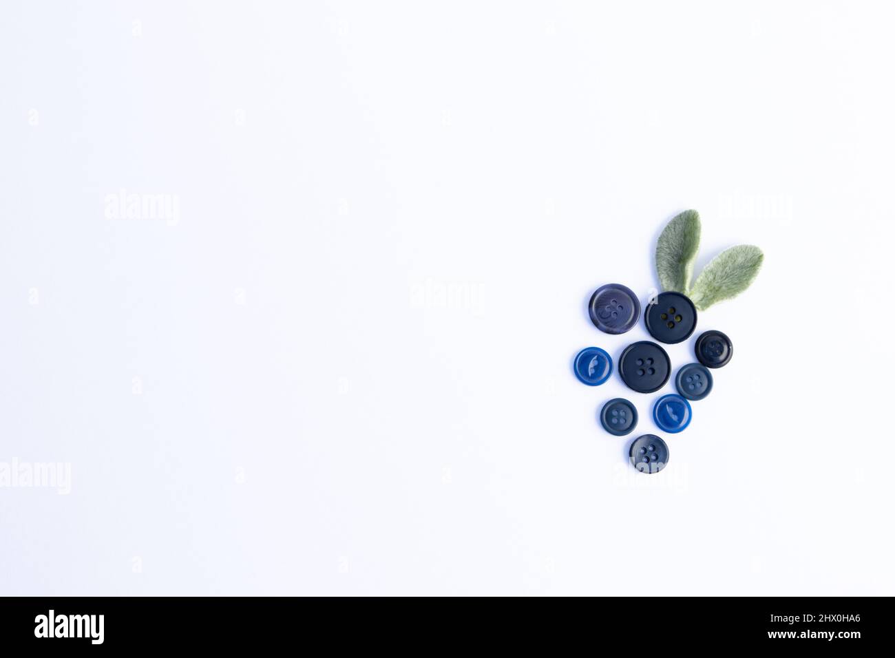 Abstract blueberries made with buttons and leaves Stock Photo - Alamy