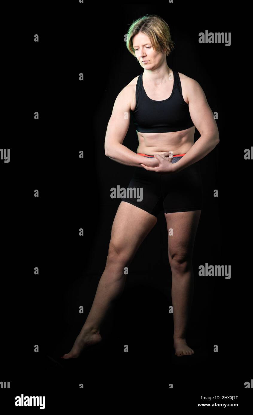 Low key full length portrait of a 35 year old white woman in fitness clothes,  Brussels Stock Photo - Alamy